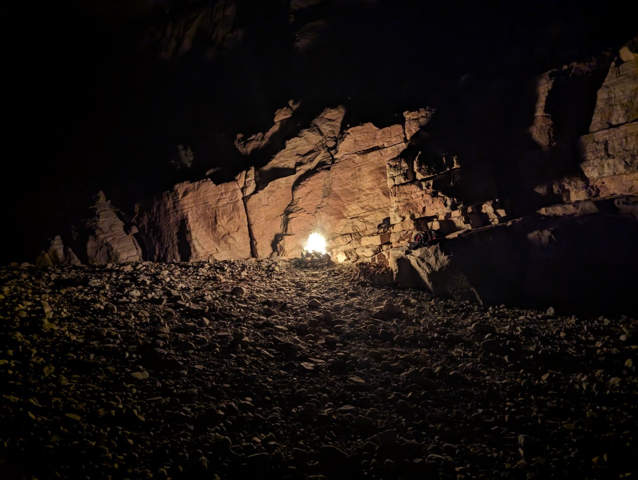 A fire against a rock background at night