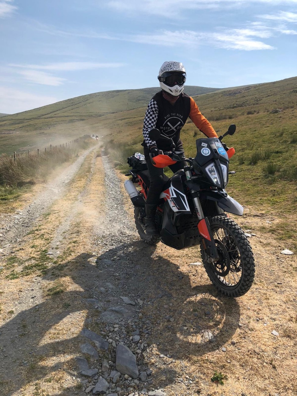 Rachel sat on her motorbike as she ascends a dirt track in Wales