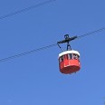 Red cable car with a white roof