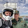 A selfie of myself, wearing a motorbike helmet, and an Algerian policeman